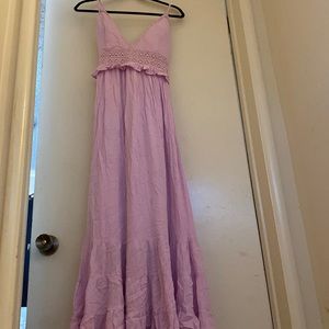 long lavender dress with a floral lace detail and a cross back